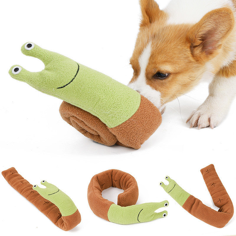Dog nosing the unrolled snail snuffle toy for treats