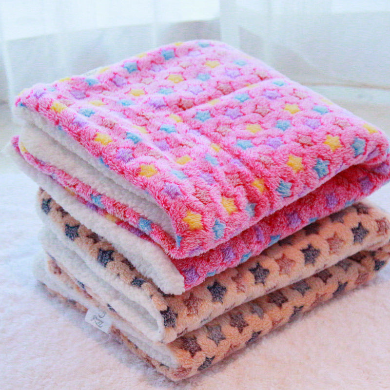 Folded stack of pink and beige star fleece blankets