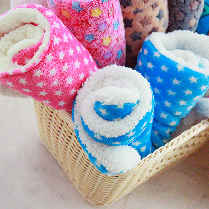Pink star and blue fleece pet blankets rolled in a basket
