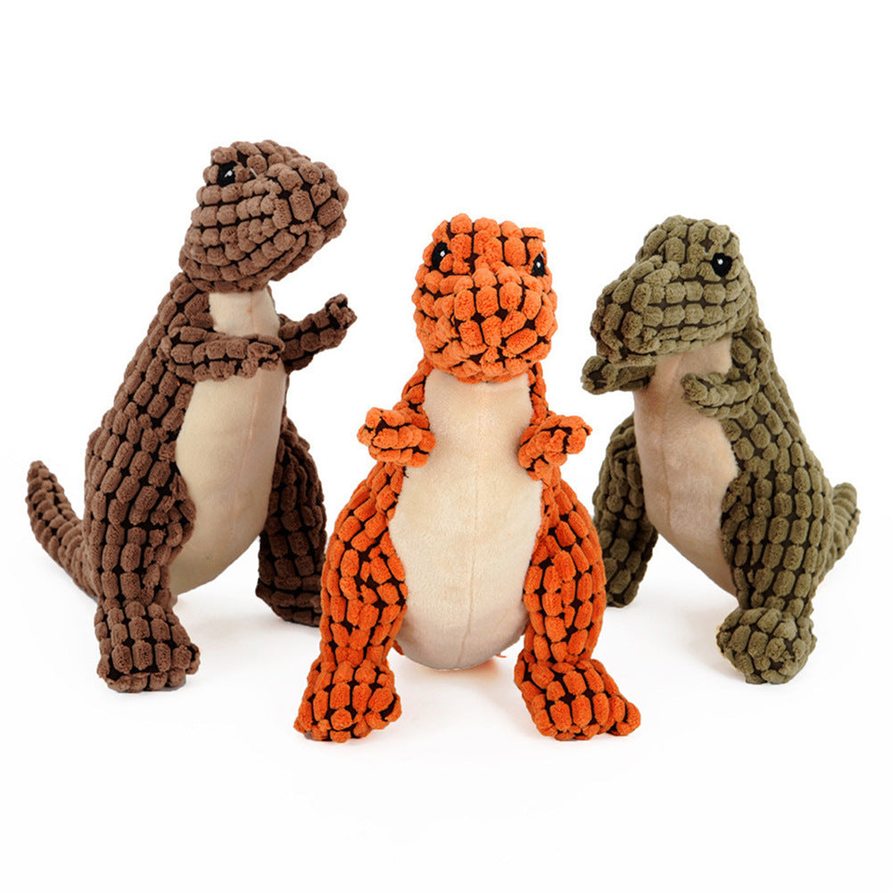 Brown, orange and green plush dinosaur dog toys together