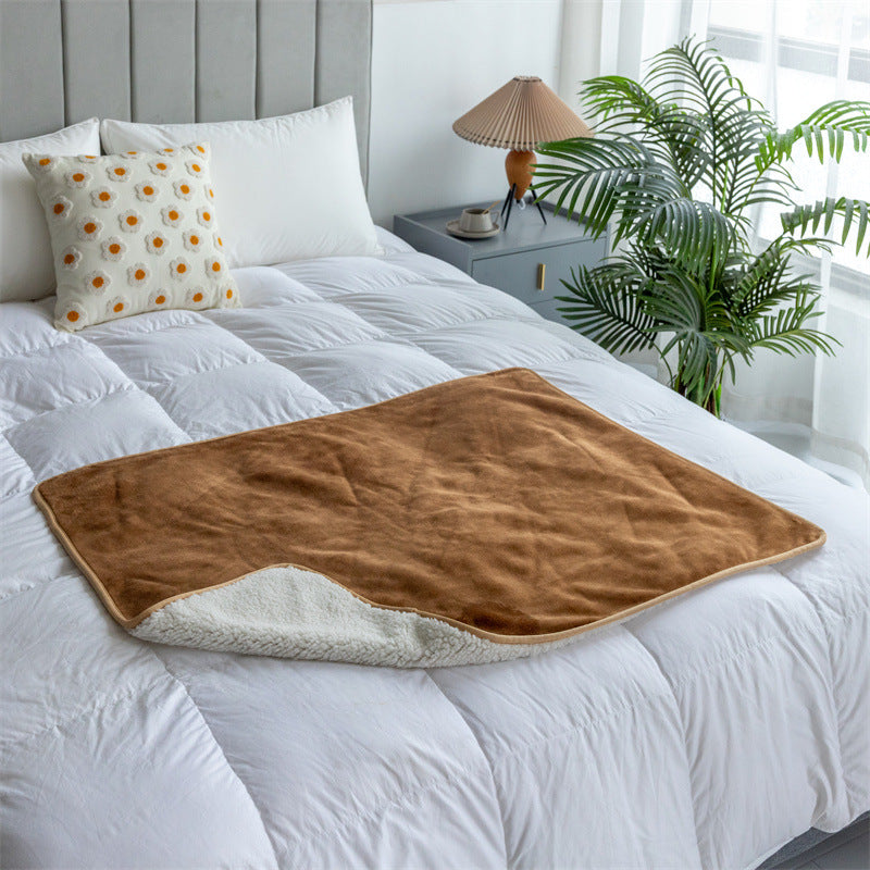 Camel washable pee pad blanket on a bed