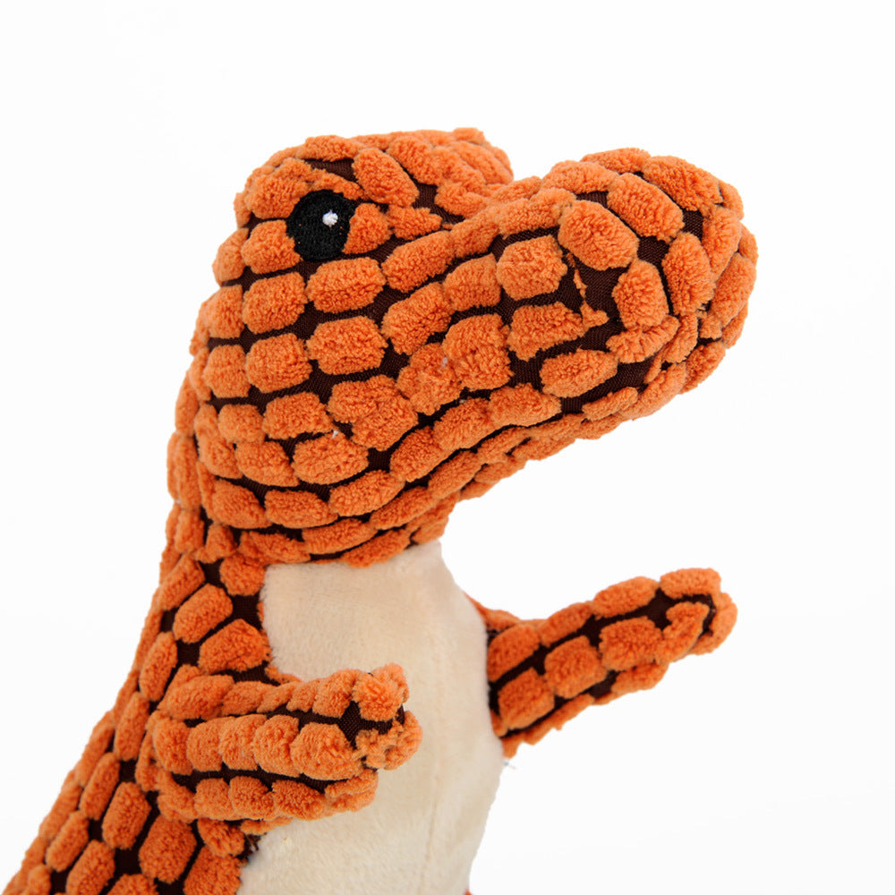 Orange plush dinosaur dog toy, side view